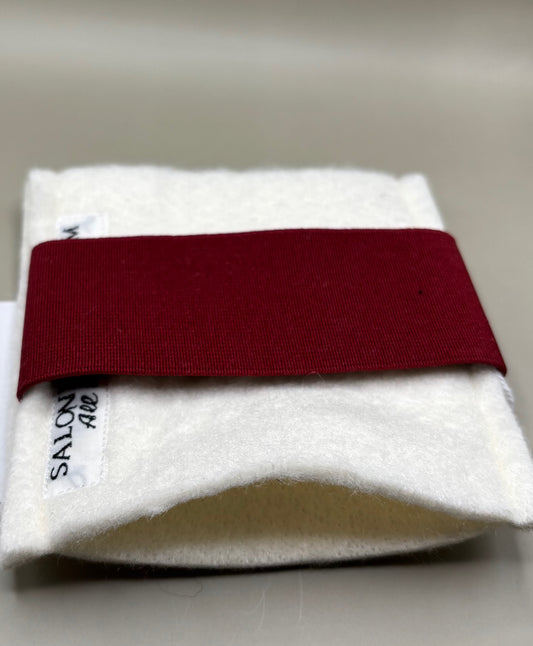 Thin pressing pad with light tan pad and black or burgundy strap, includes inner liner for gentle pressing, ideal for fine hair and smooth glide styling.