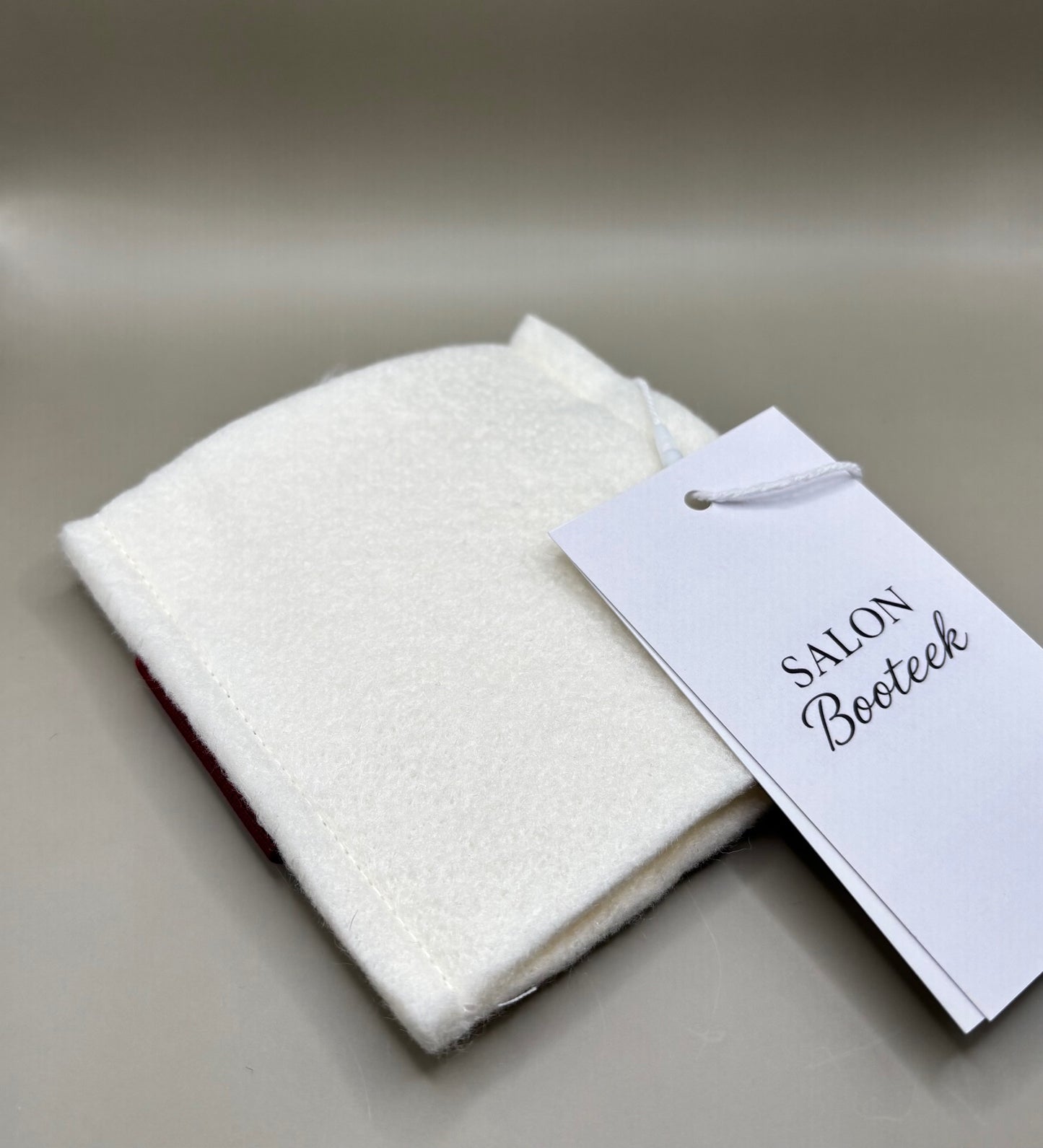 Thin pressing pad with light tan pad and black or burgundy strap, includes inner liner for gentle pressing, ideal for fine hair and smooth glide styling.