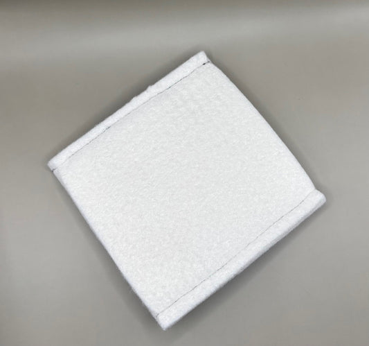 Plush pressing pad with light tan pad and black strap, thick design for everyday hair pressing, suitable for fine to thick hair textures.