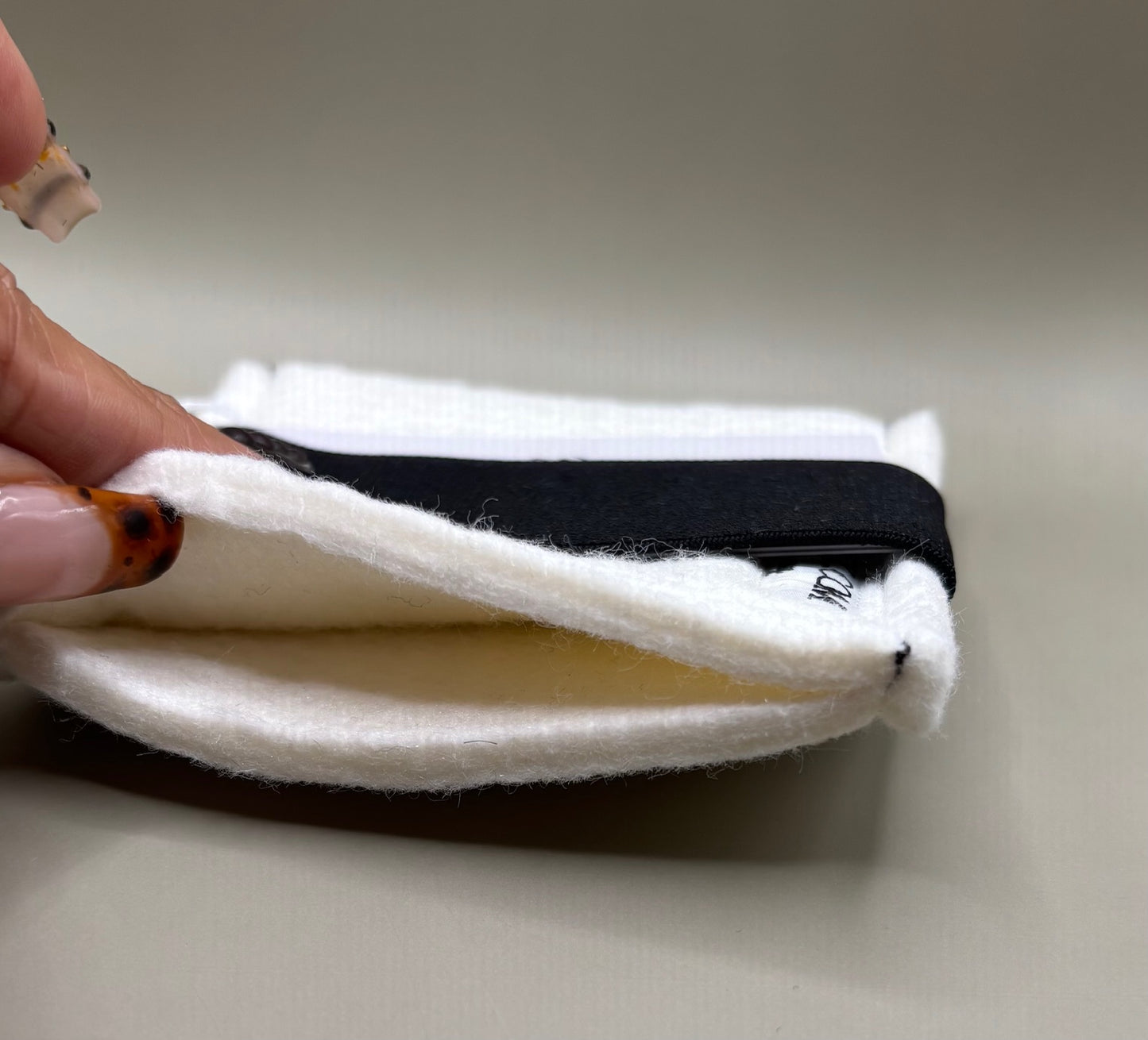 Plush pressing pad with light tan pad and black strap, thick design for everyday hair pressing, suitable for fine to thick hair textures.