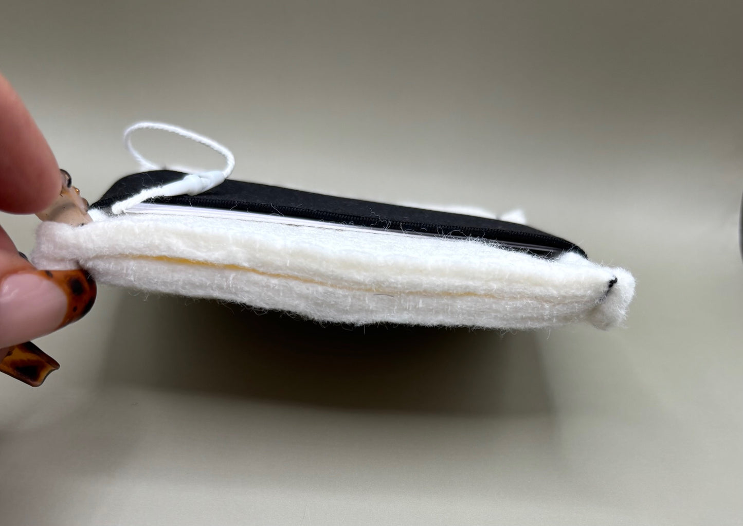 Plush pressing pad with light tan pad and black strap, thick design for everyday hair pressing, suitable for fine to thick hair textures.