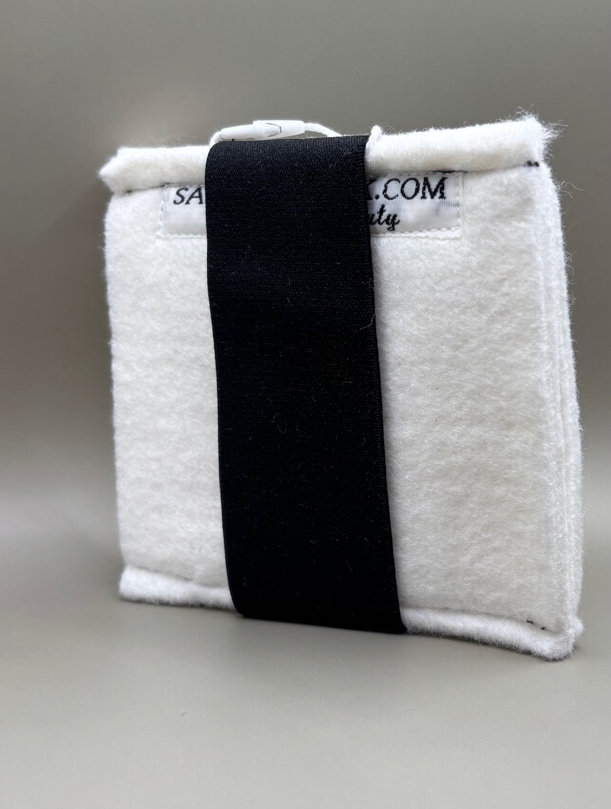 Plush pressing pad with light tan pad and black strap, thick design for everyday hair pressing, suitable for fine to thick hair textures.