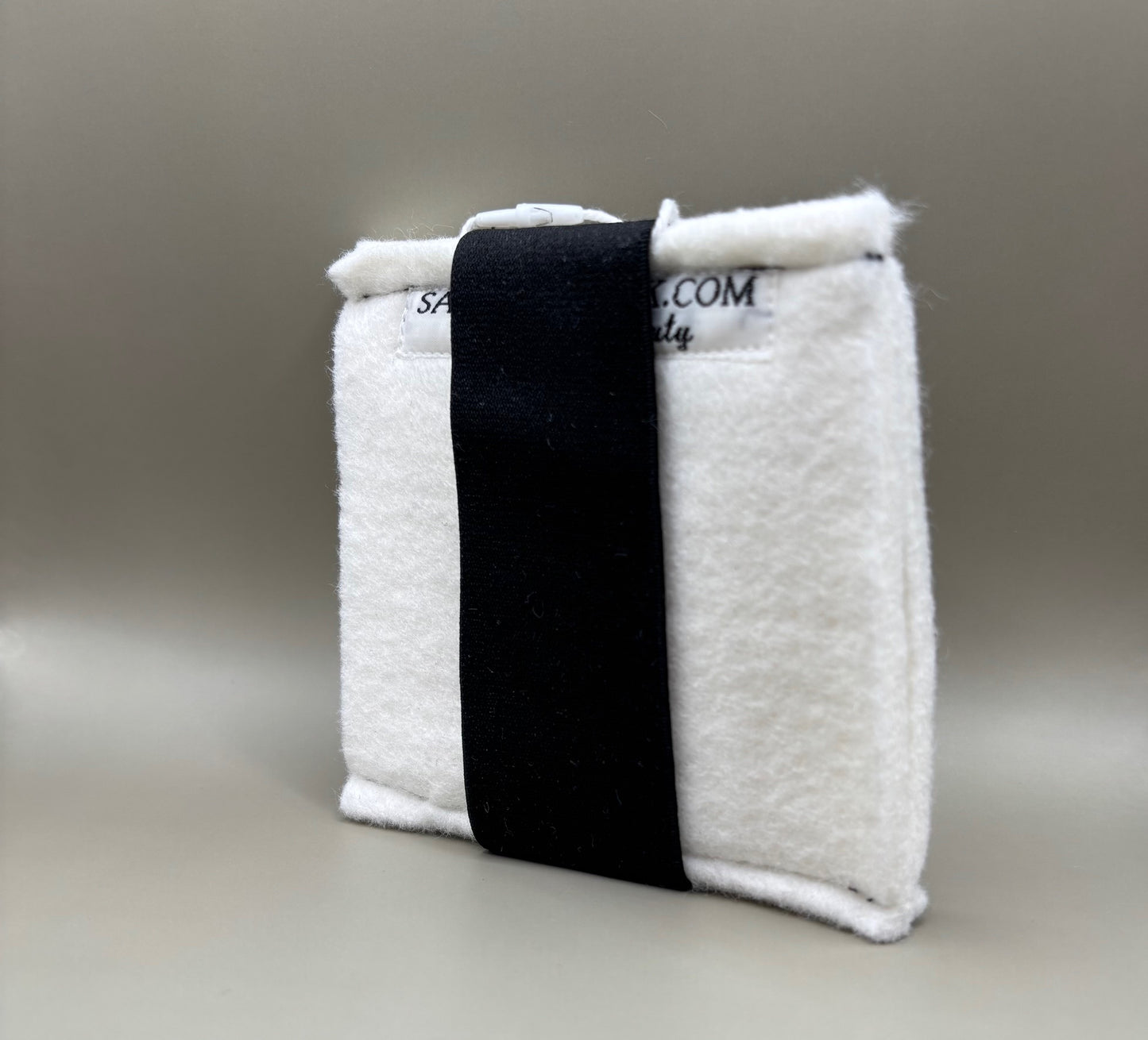 Plush pressing pad with light tan pad and black strap, thick design for everyday hair pressing, suitable for fine to thick hair textures.