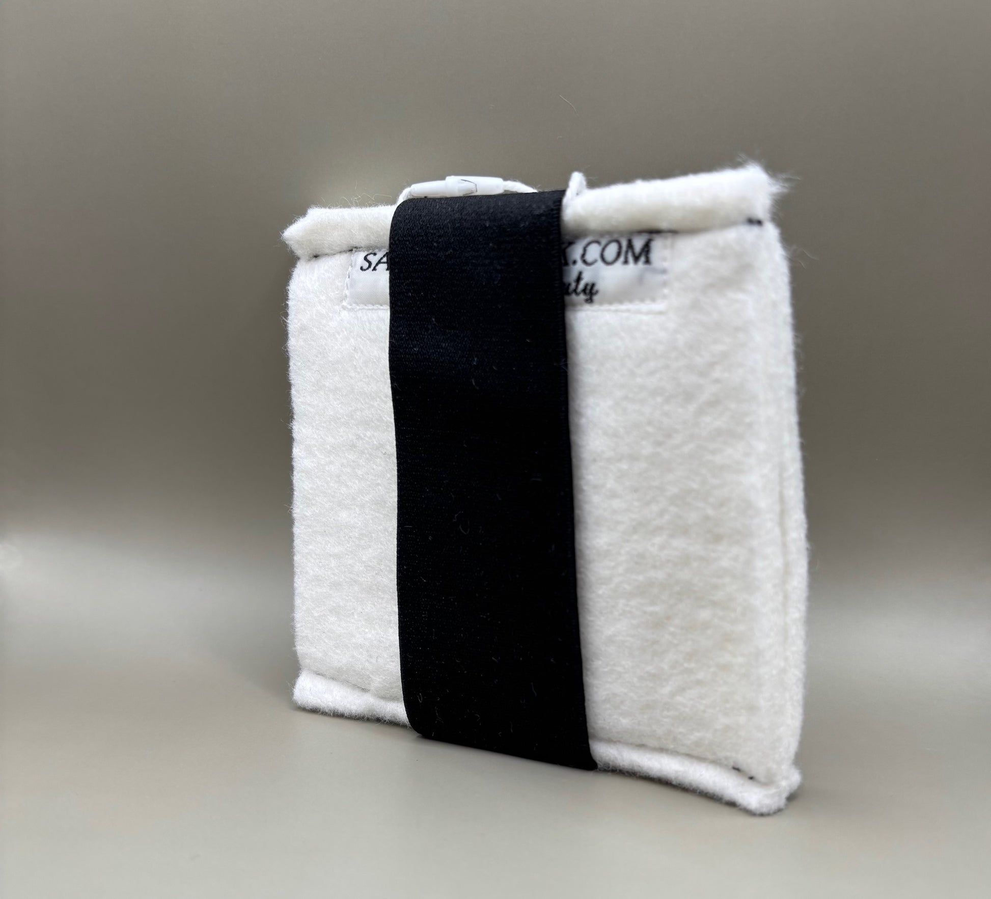 Plush pressing pad with light tan pad and black strap, thick design for everyday hair pressing, suitable for fine to thick hair textures.