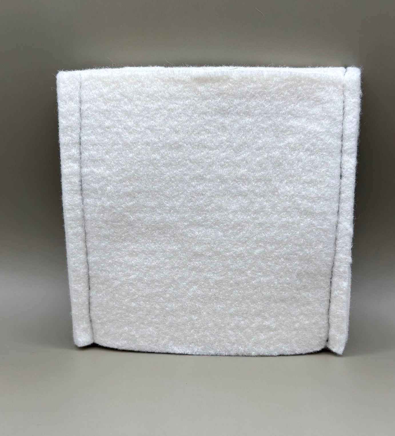 Plush pressing pad with light tan pad and black strap, thick design for everyday hair pressing, suitable for fine to thick hair textures.