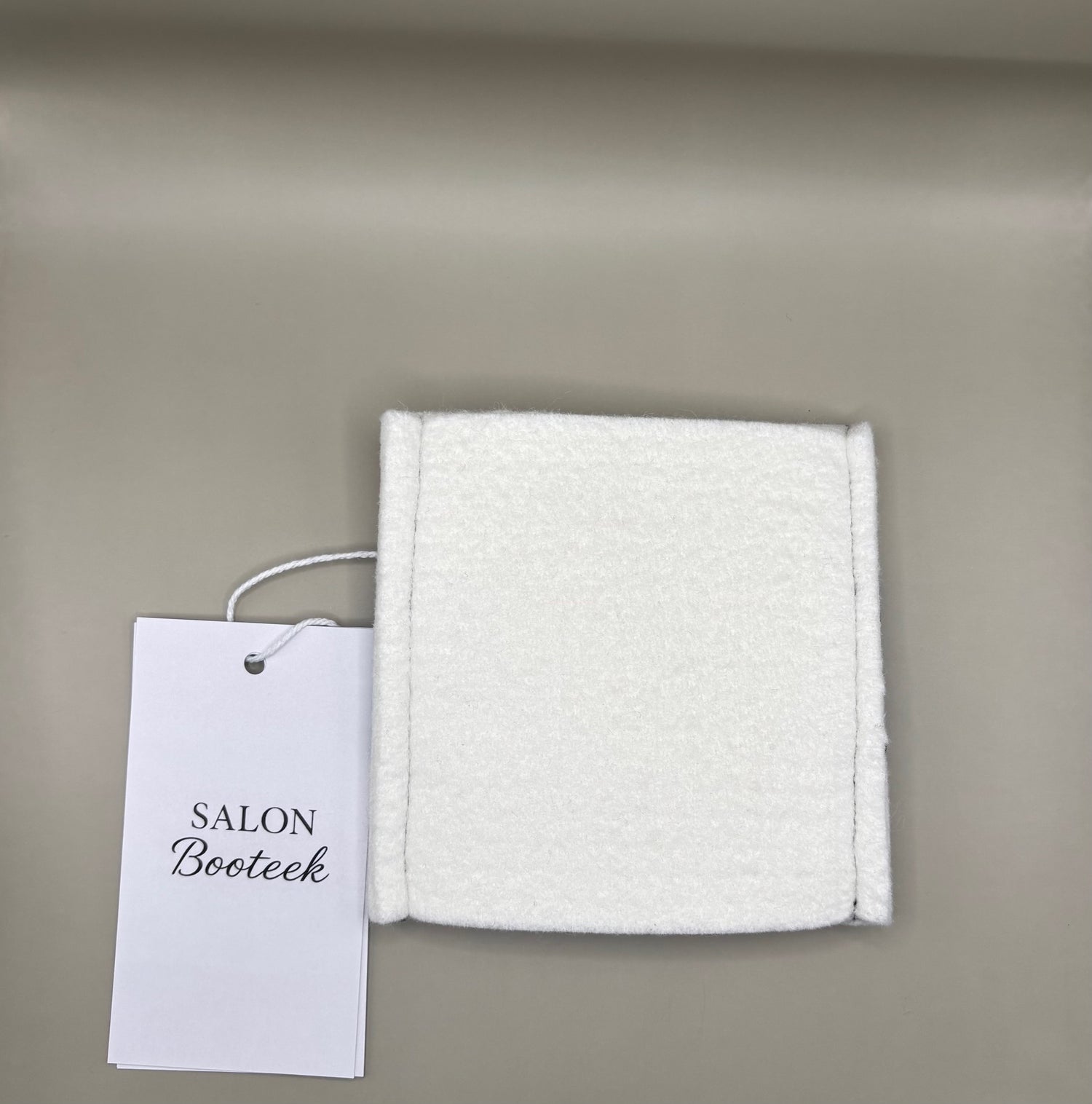 Thin pressing pad with light tan pad and black or burgundy strap, includes inner liner for gentle pressing, ideal for fine hair and smooth glide styling.