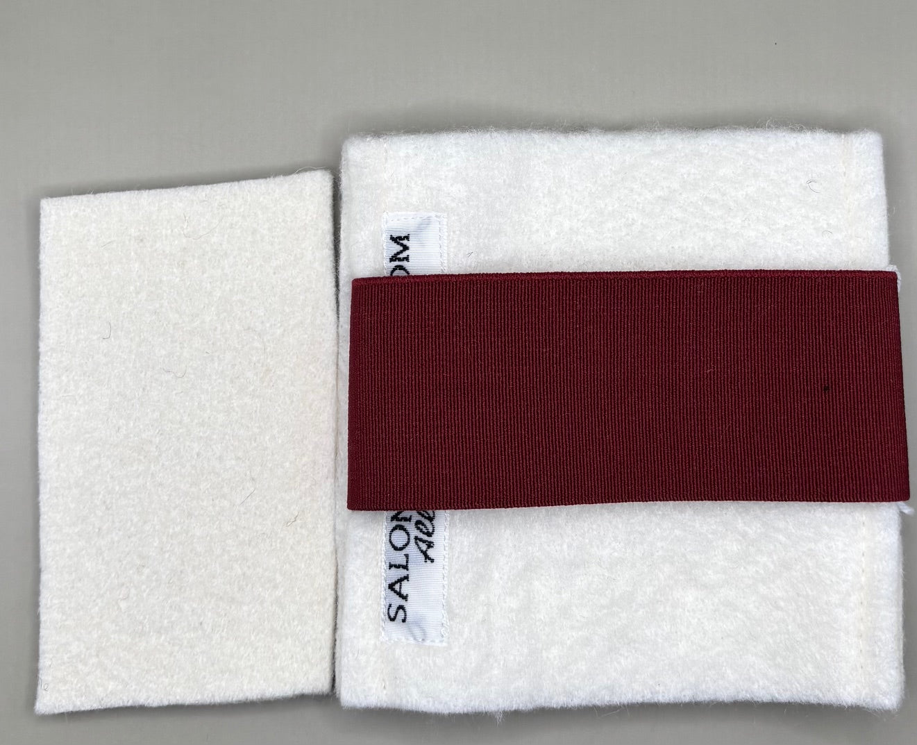 Thin pressing pad with light tan pad and black or burgundy strap, includes inner liner for gentle pressing, ideal for fine hair and smooth glide styling.